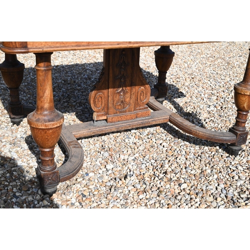 288 - A 19th century French oak dining table with parquetry top, turned supports united by curved stretche... 