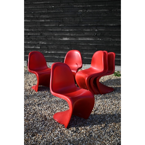 A set of six Vitra Panton style red plastic stacking dining chairs (6)