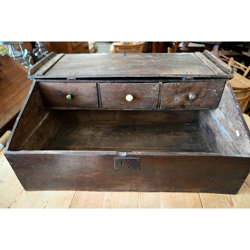 363 - An 18th century oak slope top clerks desk, the interior fitted with three drawers, 90 cm wide x 50 c... 