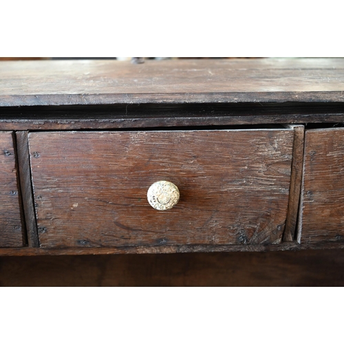 363 - An 18th century oak slope top clerks desk, the interior fitted with three drawers, 90 cm wide x 50 c... 