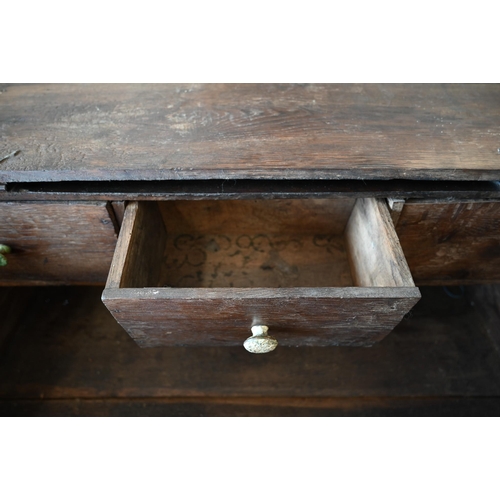 363 - An 18th century oak slope top clerks desk, the interior fitted with three drawers, 90 cm wide x 50 c... 