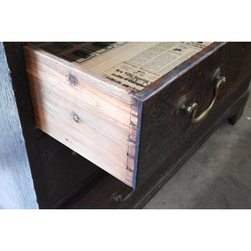 364 - A 19th century oak linen press, the panelled doors enclosing five slides on base with five drawers r... 