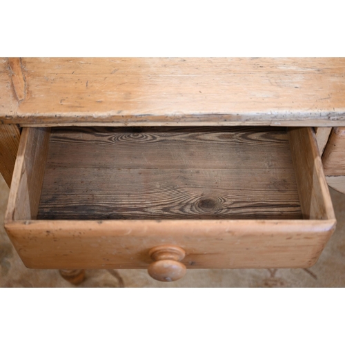 369 - A waxed pine kitchen/pantry side table with three drawers raised on turned supports, 150 cm wide x 7... 