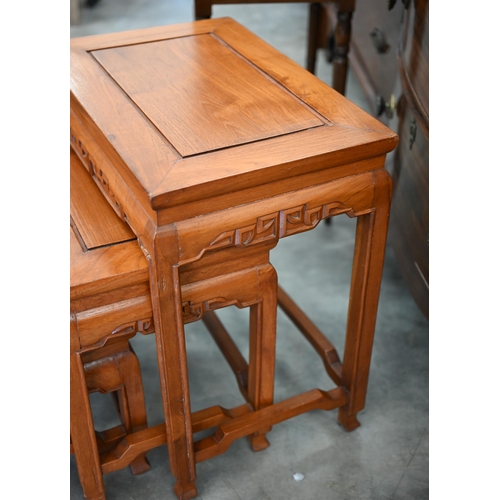 371 - A Chinese nest of three hardwood tables, the largest 48 cm wide x 32 cm deep x 54 cm high