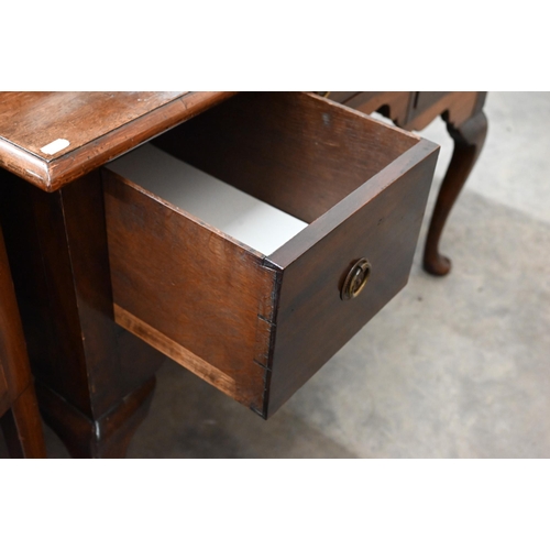 381 - A 19th century mahogany dressing table with three drawers around shaped niche raised on cabriole sup... 