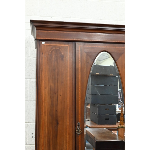 383 - Edwardian walnut and satin-banded wardrobe, the single door inset with bevelled oval mirror on base ... 