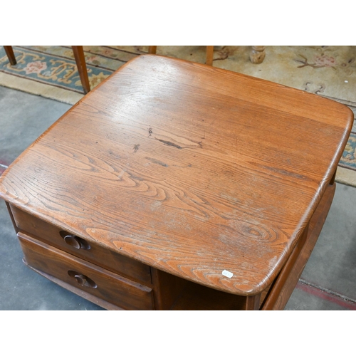 390 - An Ercol (attributed/unmarked) elm Pandora coffee table, with two drawers and open sides on casters,... 