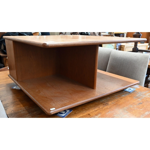 392 - A 1980s teak G-Plan coffee table with open compartmentalised sides on roller casters, 80 x 80 x 40 c... 