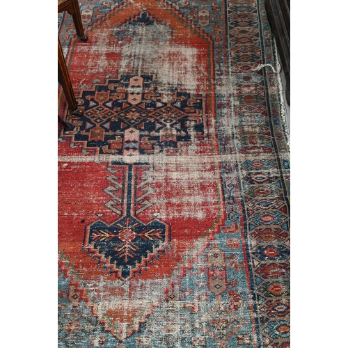 396 - A North West Persian kavabagh rug, navy medallion on red ground with blue borders,181 x 118 cm to/w ... 