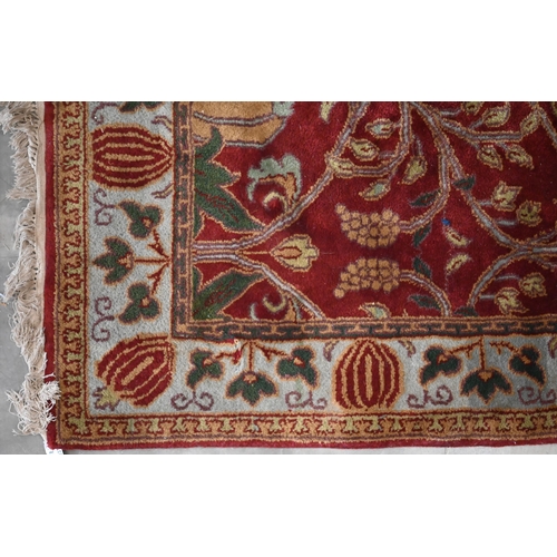 397 - A red ground Agra rug, floral and foliate design on red ground with turquoise border, 186 x 124 cm