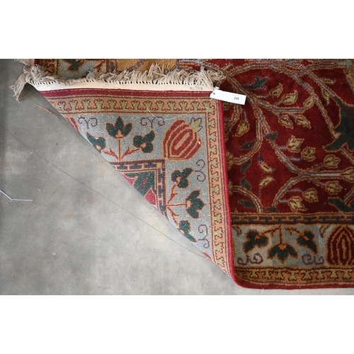 397 - A red ground Agra rug, floral and foliate design on red ground with turquoise border, 186 x 124 cm