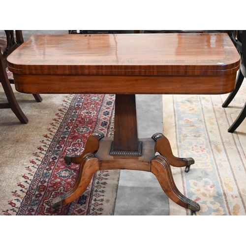 405 - A Regency mahogany card table with folding rosewood banded top (baise lined), on tapering rectangula... 