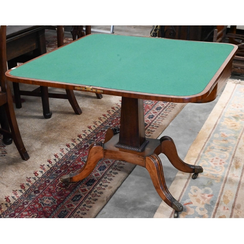 405 - A Regency mahogany card table with folding rosewood banded top (baise lined), on tapering rectangula... 