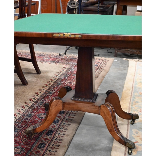 405 - A Regency mahogany card table with folding rosewood banded top (baise lined), on tapering rectangula... 