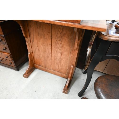 410 - A mid 20th century oak clerk's desk with hinged sloped top on a panelled base with high chair, 98 cm... 