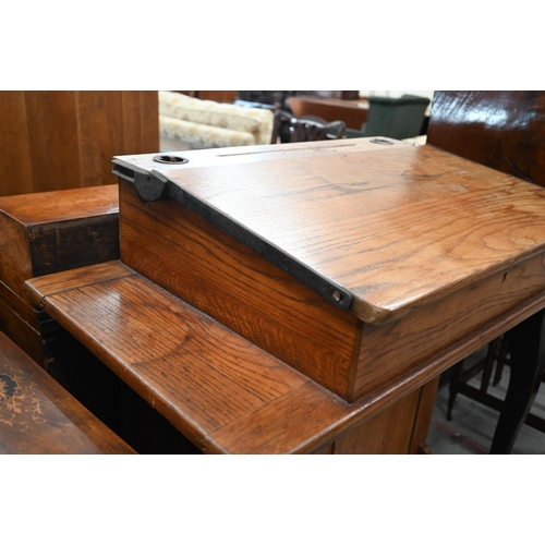 410 - A mid 20th century oak clerk's desk with hinged sloped top on a panelled base with high chair, 98 cm... 