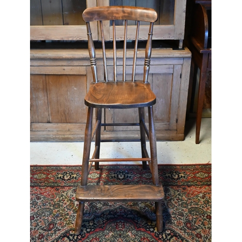 410 - A mid 20th century oak clerk's desk with hinged sloped top on a panelled base with high chair, 98 cm... 