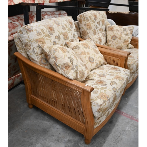 415 - An Ercol ash and woven cane bergere three pieces suite, two seater sofa and pair of armchairs, uphol... 