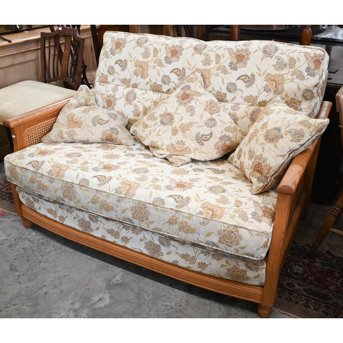 415 - An Ercol ash and woven cane bergere three pieces suite, two seater sofa and pair of armchairs, uphol... 