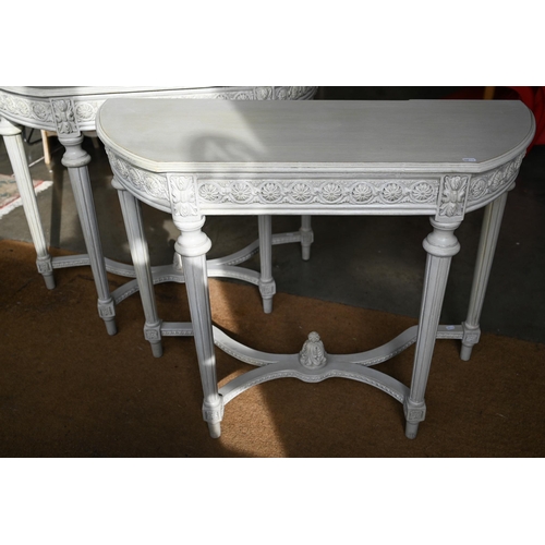 417 - A pair of French style console tables, the rosette carved frieze on fluted supports united by stretc... 