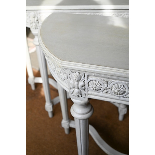 417 - A pair of French style console tables, the rosette carved frieze on fluted supports united by stretc... 