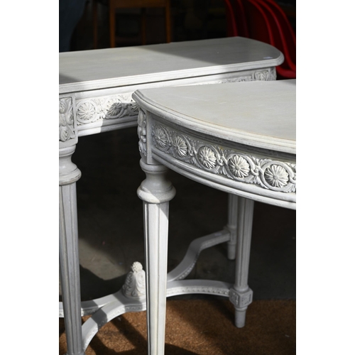 417 - A pair of French style console tables, the rosette carved frieze on fluted supports united by stretc... 