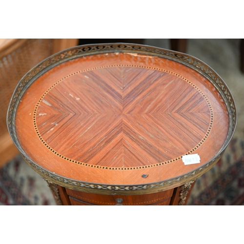 418 - A reproduction French kingwood inlaid oval side table with pierced brass gallery and three drawers, ... 