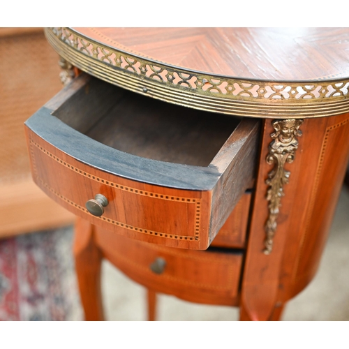 418 - A reproduction French kingwood inlaid oval side table with pierced brass gallery and three drawers, ... 