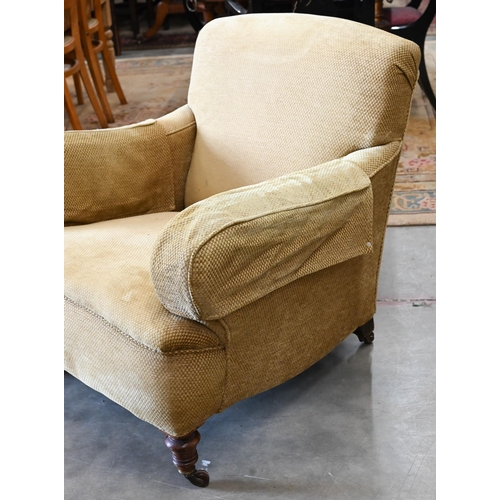 423 - A mahogany framed upholstered armchair on turned front legs with casters, 90 cm d x 85 cm w x 77 cm ... 