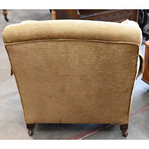 423 - A mahogany framed upholstered armchair on turned front legs with casters, 90 cm d x 85 cm w x 77 cm ... 