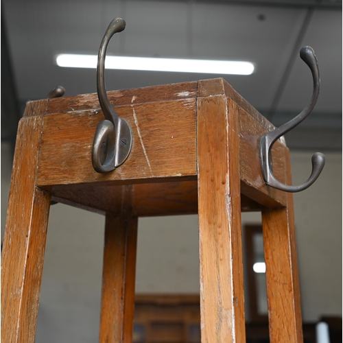 427 - An Arts & Crafts oak hall stand with coat hooks and stick/umbrella stand fitted with metal drip ... 