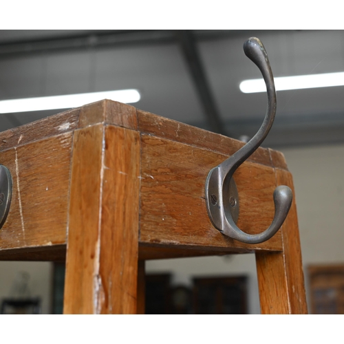 427 - An Arts & Crafts oak hall stand with coat hooks and stick/umbrella stand fitted with metal drip ... 