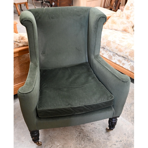 437 - An early 20th century mahogany framed wingback armchair, green corduroy fabric