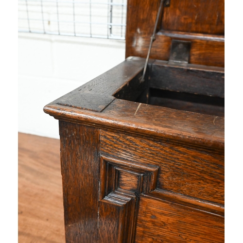 445 - A panelled oak slipper/coal box on bun feet, 50 x 36 x 36 cm h