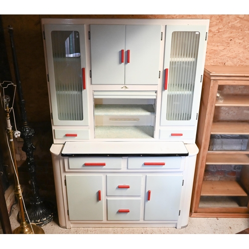 451 - A 1950s kitchen utility cabinet with sliding enamelled work surface beneath a tambour cabinet front ... 