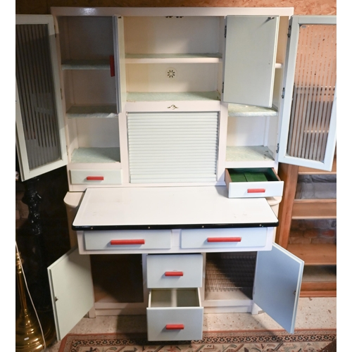 451 - A 1950s kitchen utility cabinet with sliding enamelled work surface beneath a tambour cabinet front ... 