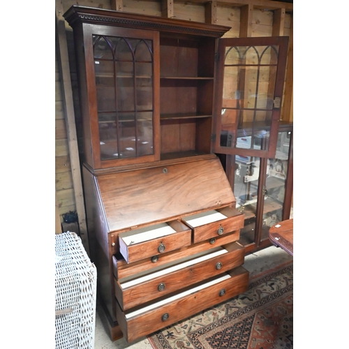 453 - A 19th century mahogany fall front bureau bookcase, with twin arched glazed cabinet doors over a fit... 