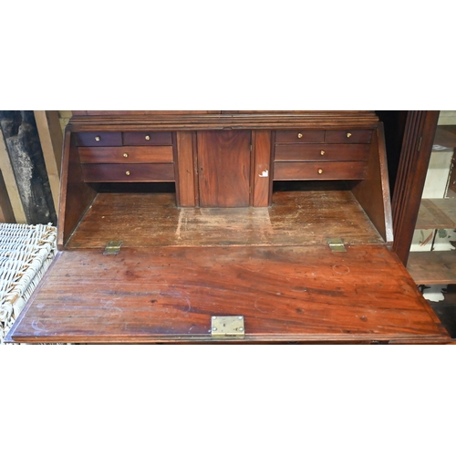 453 - A 19th century mahogany fall front bureau bookcase, with twin arched glazed cabinet doors over a fit... 