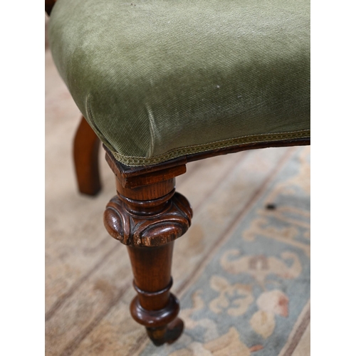 458 - A 19th century oak framed bow-back elbow chair with green dralon upholstery