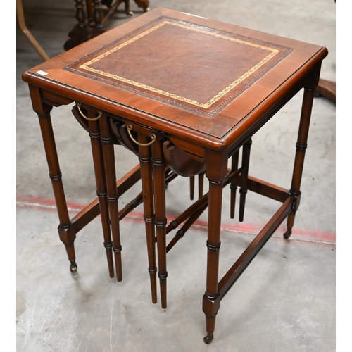 465 - A mahogany side table with gilt tooled leather top and two nesting drop leaf tables, all with 'bambo... 