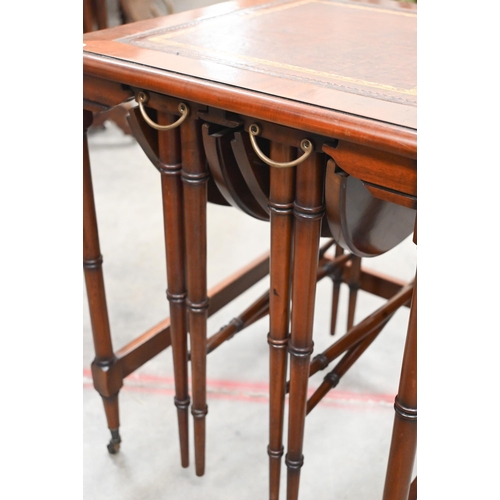 465 - A mahogany side table with gilt tooled leather top and two nesting drop leaf tables, all with 'bambo... 