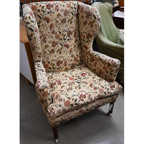 468 - A Georgian style wingback armchair with floral upholstery