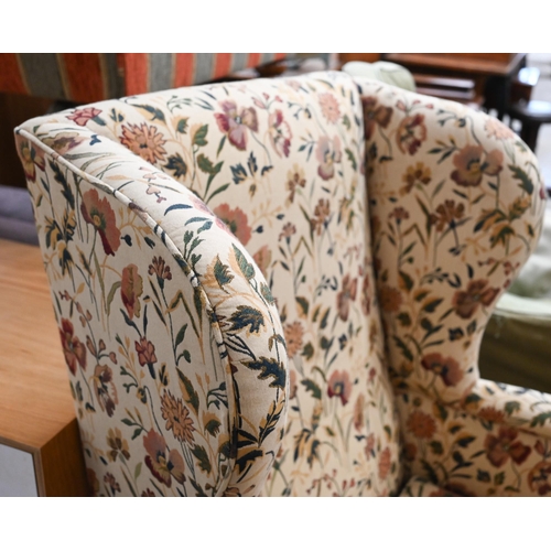 468 - A Georgian style wingback armchair with floral upholstery