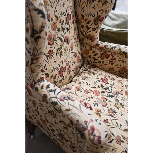 468 - A Georgian style wingback armchair with floral upholstery