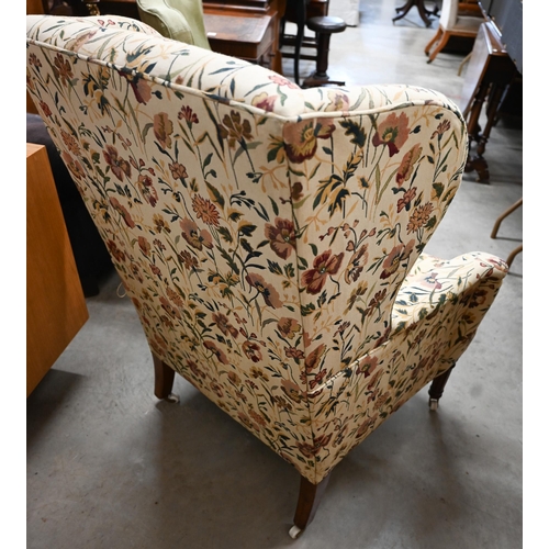 468 - A Georgian style wingback armchair with floral upholstery