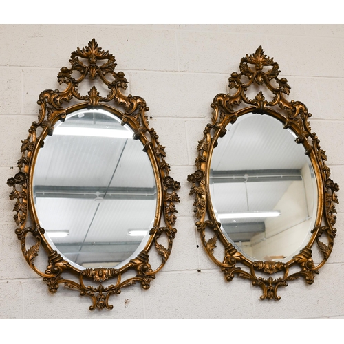 480 - A pair of oval gilt-framed mirrors with floral decorative framed 115 x 68cm