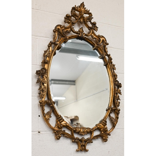 480 - A pair of oval gilt-framed mirrors with floral decorative framed 115 x 68cm