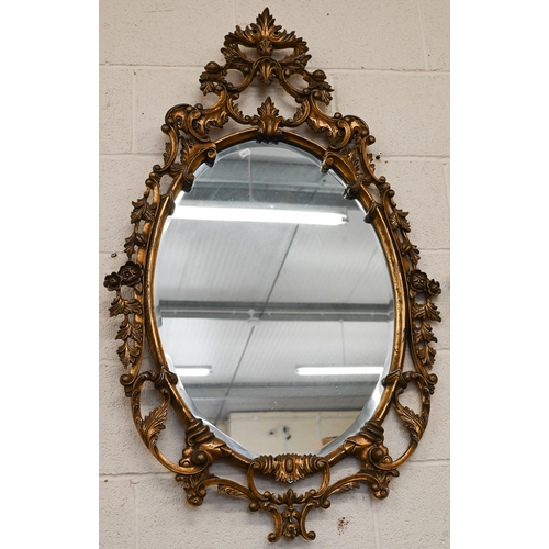 480 - A pair of oval gilt-framed mirrors with floral decorative framed 115 x 68cm