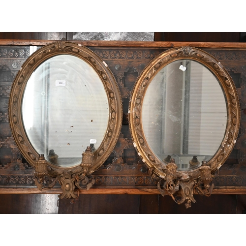 500 - A pair of antique gilt-framed girandole mirrors with oval plates and twin branches (a/f)