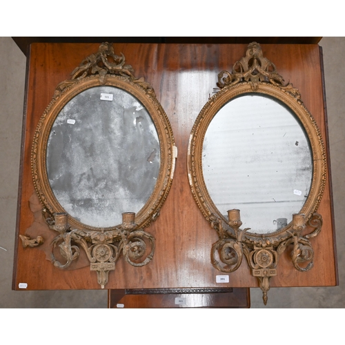 501 - An antique pair oval gilt girandole mirrors with twin branches, 82 x 46cm